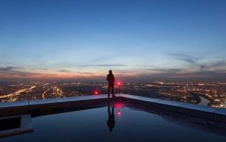 Image of man standing overlooking the skyline, represents 1Up's commitment to visionary thinking and unafraid of challenges